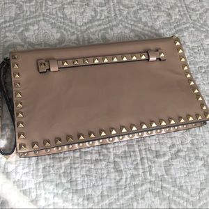Valentino gold stud patent leather clutch.